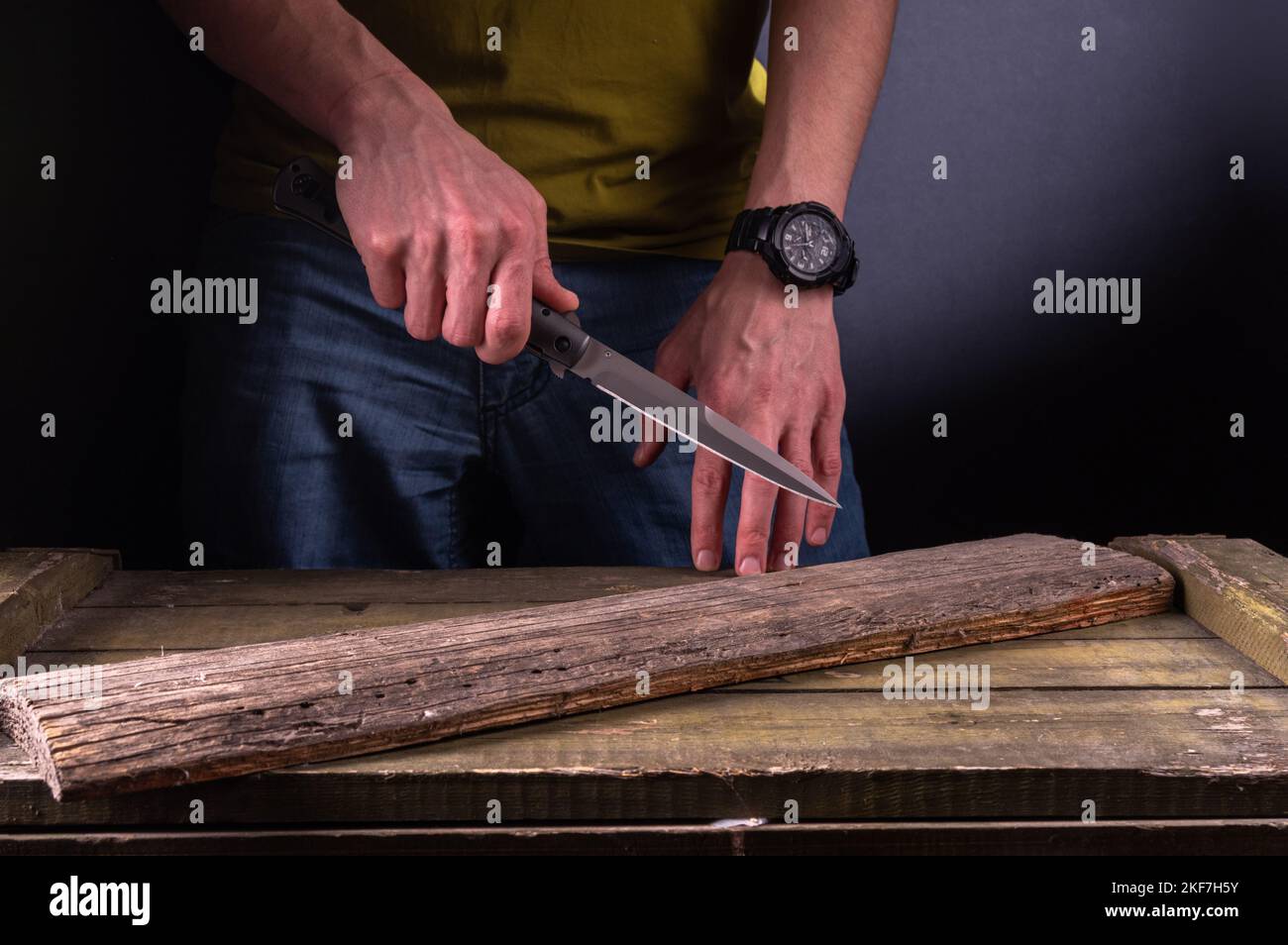 The man holds a sharp knife in his hand. Hit with a sharp knife. Big