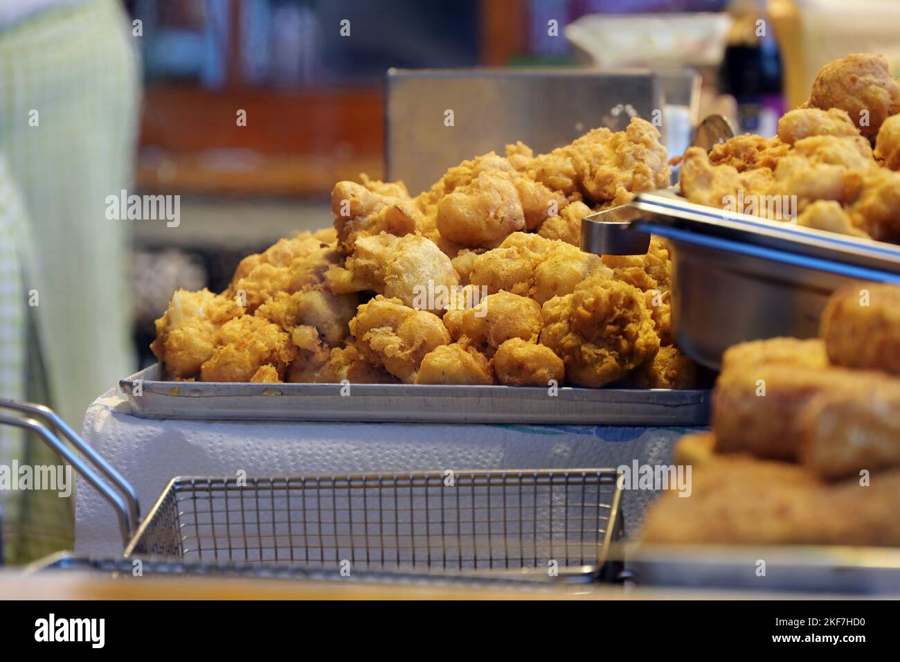 Deep fried sweet pastry, common carnival fair snack offered in stalls on markets around Christmas in Germany, selected focus, narrow depth of field Stock Photo