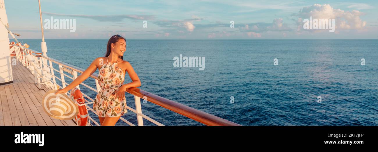 Cruise woman relaxing on deck watching sunset from ship on Caribbean luxury travel vacation. Panoramic banner of sea and boat. Multiracial model. Stock Photo