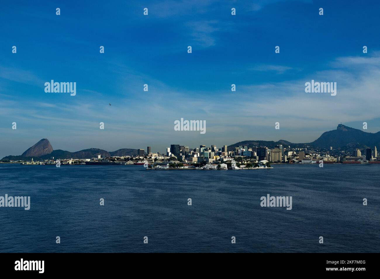 Rio de Janeiro downtown, between the landmarks Sugar Loaf and Christ the Redeemer, seen from Guanabara Bay. Stock Photo