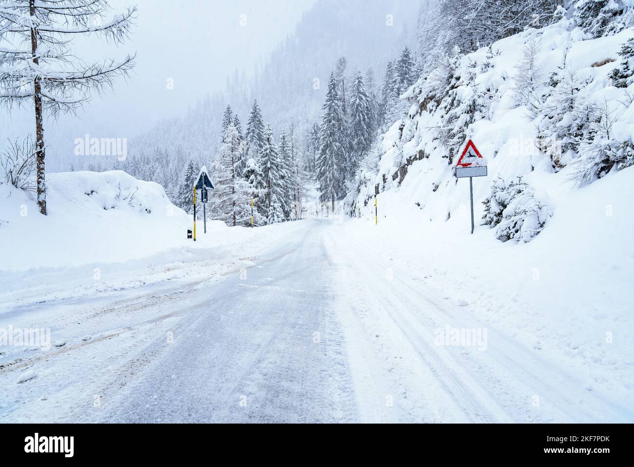 Snowy road in the European Alps during heavy snowfall Stock Photo