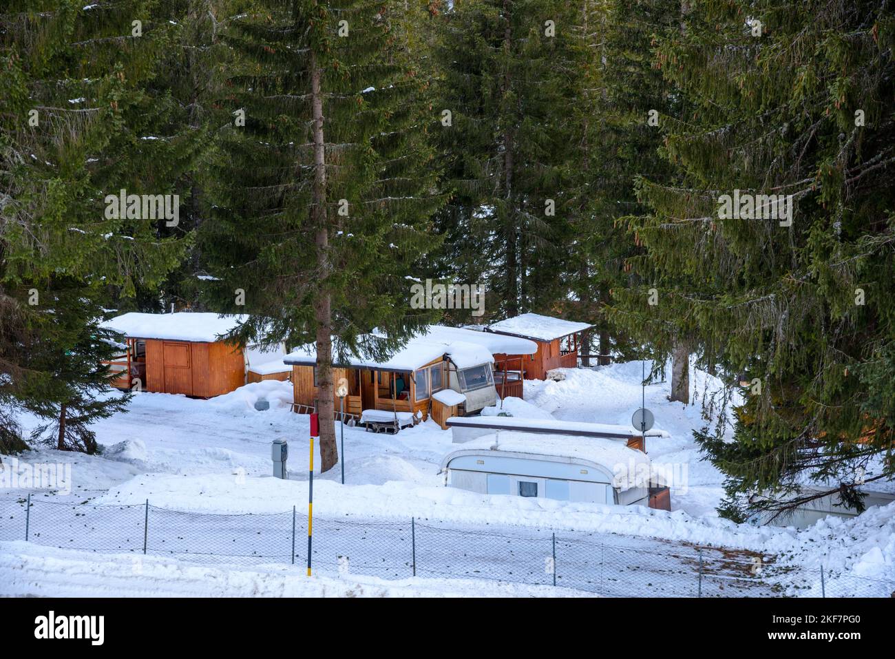 View of a campground in a snowy forest in the mountains in winter Stock Photo
