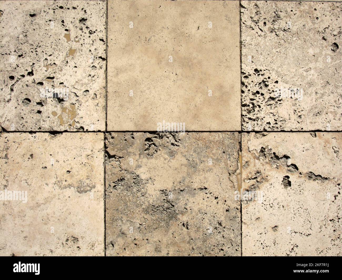 Travertine tiles fit together in outdoor flooring. Stock Photo