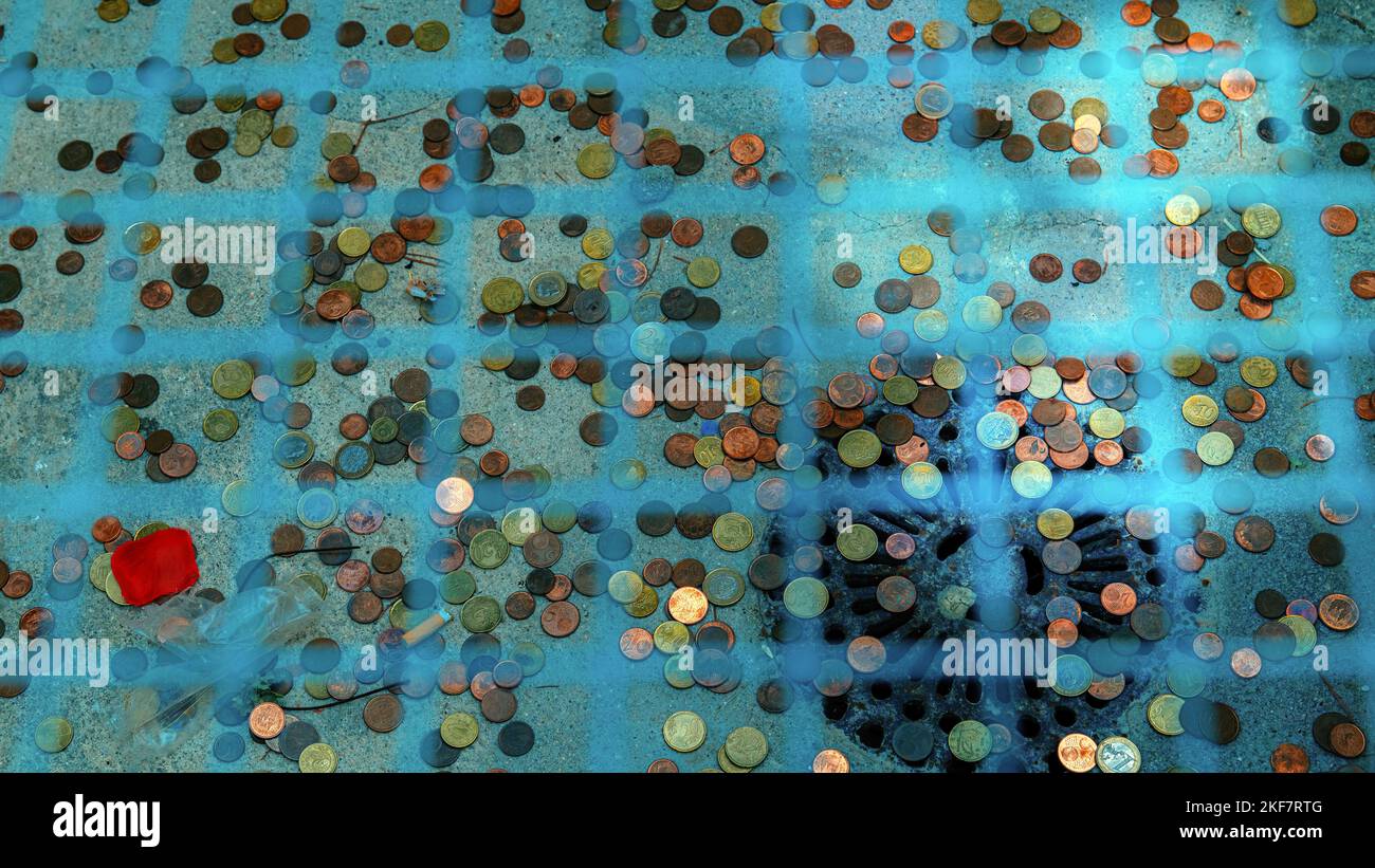 Coins thrown into wishing well Stock Photo Alamy