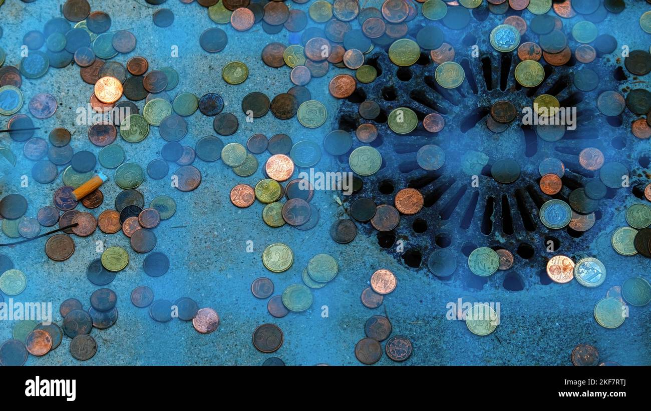 Coins thrown into wishing well Stock Photo Alamy