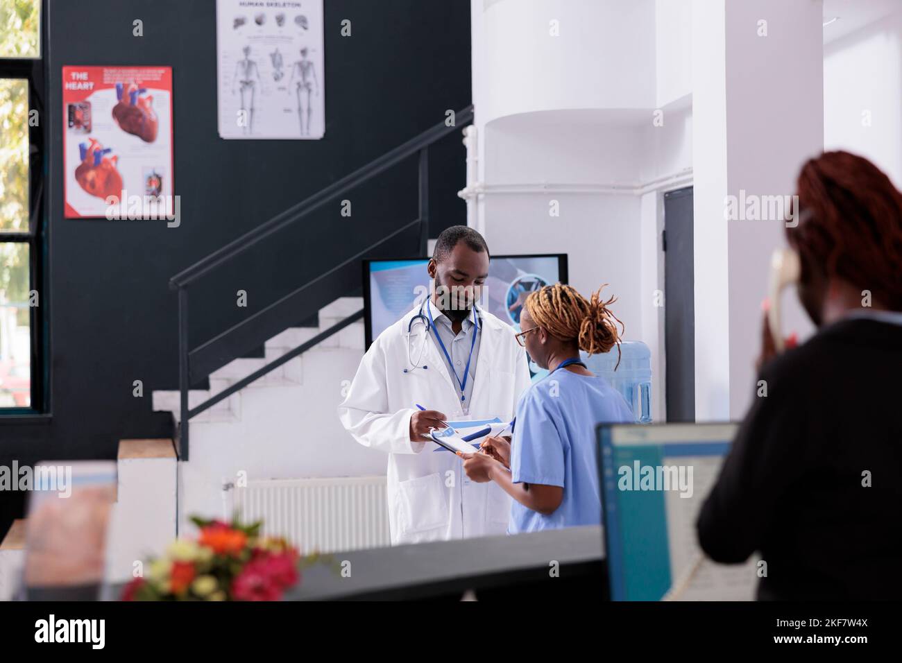 Practitioner doctor discussing health care treatment with assistant