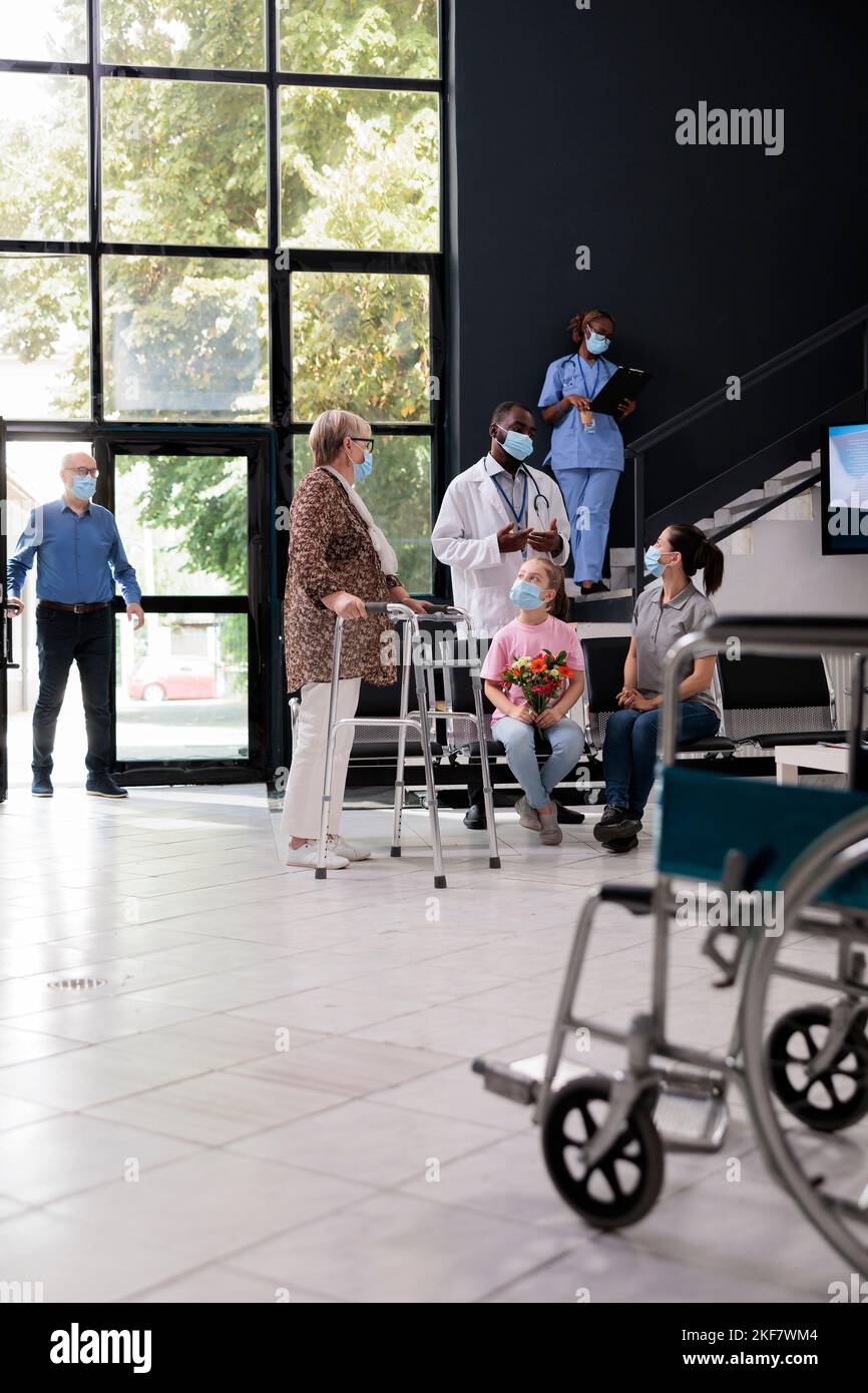 Senior woman with walking frame discussing disease diagnosis with