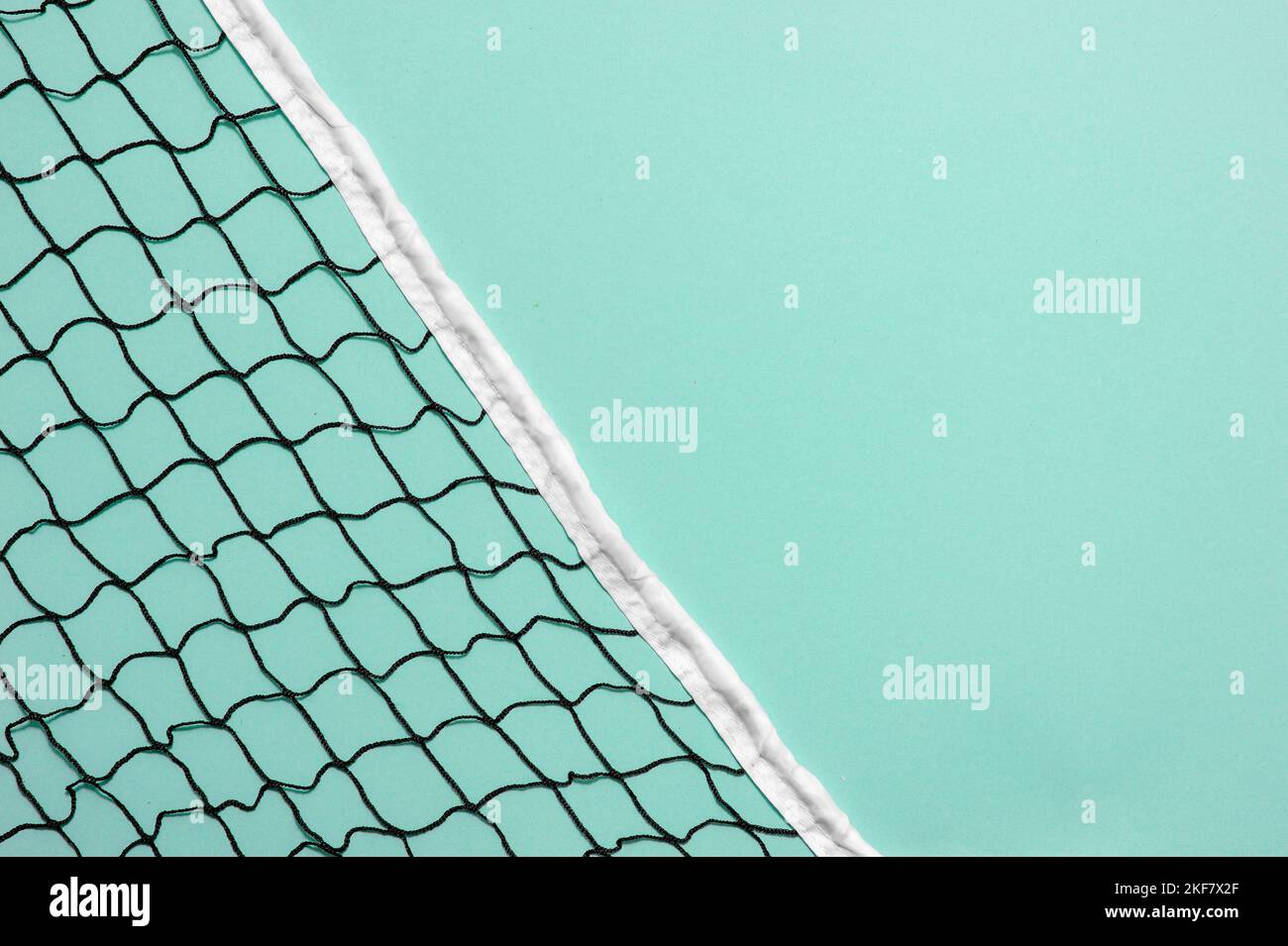 Beach volleyball and beach tennis net on mint color background