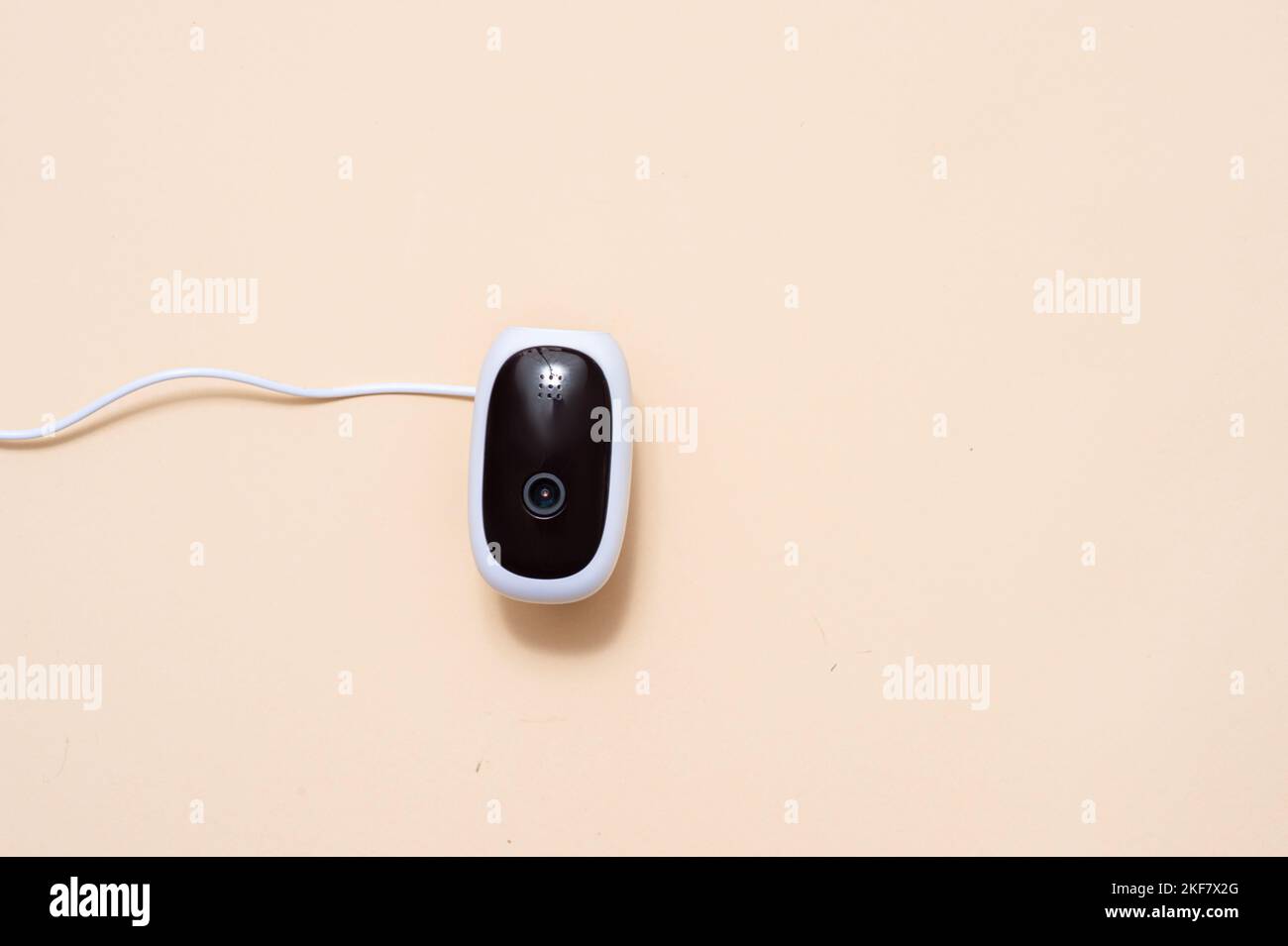 Wireless security camera isolated on beige color background. Stock Photo