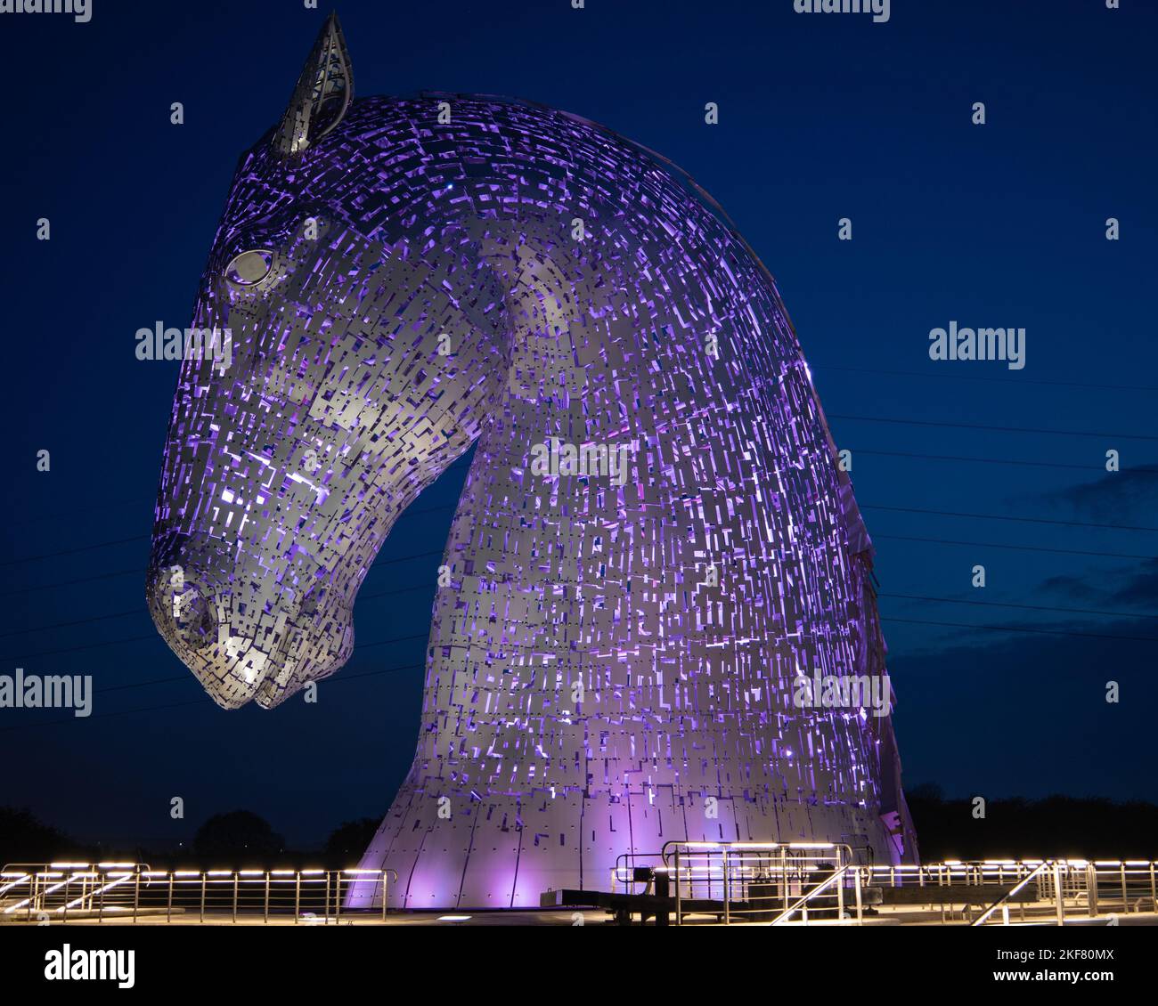 The sculpture of The Kelpies horse illuminated at night, Scotland Stock