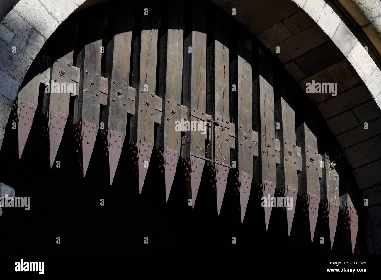 portcullis with metal spikes on a medieval gate castle in cologne Stock