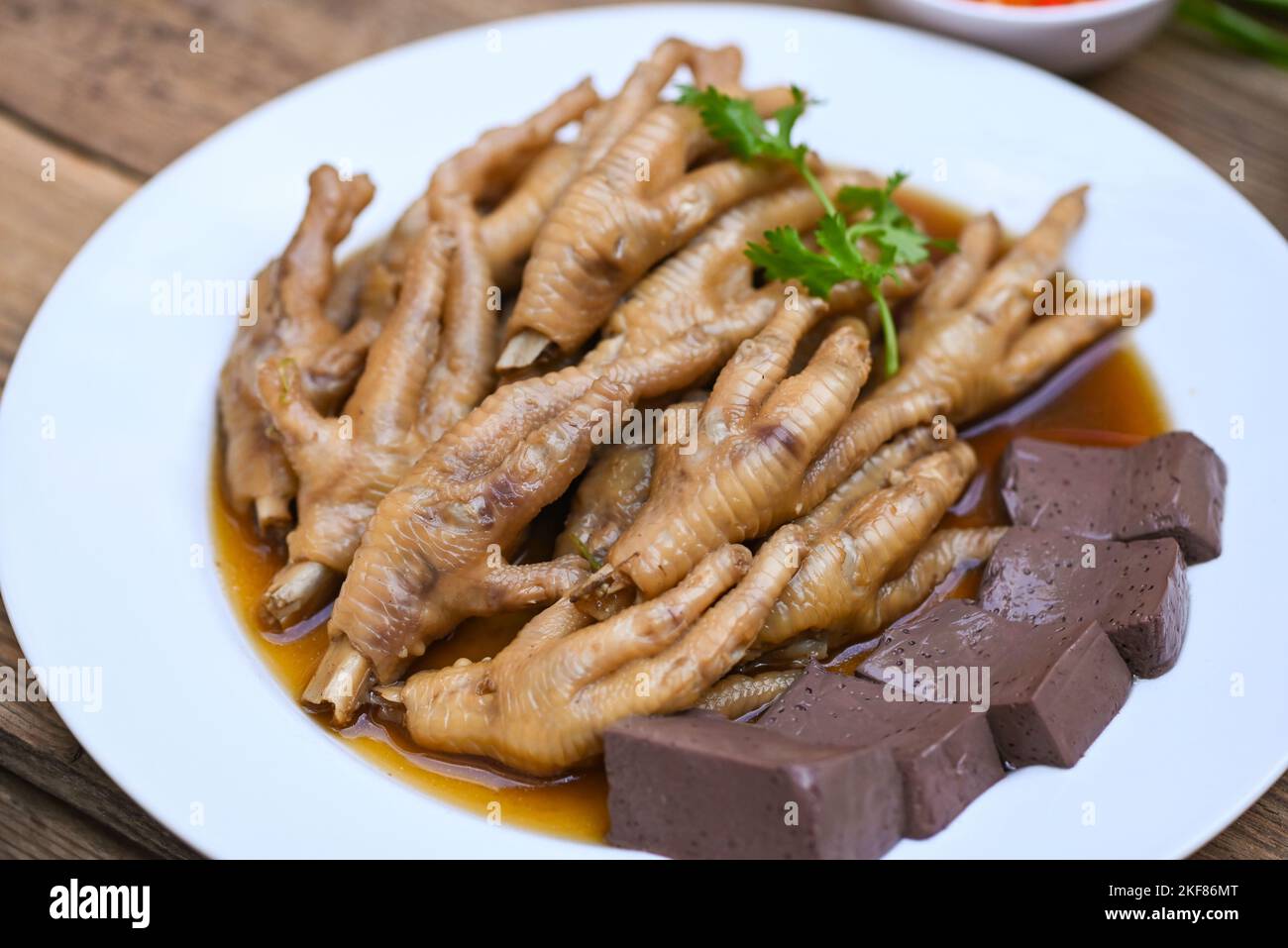 chicken feet soup stewed, cooking chicken feet foot stew on white with