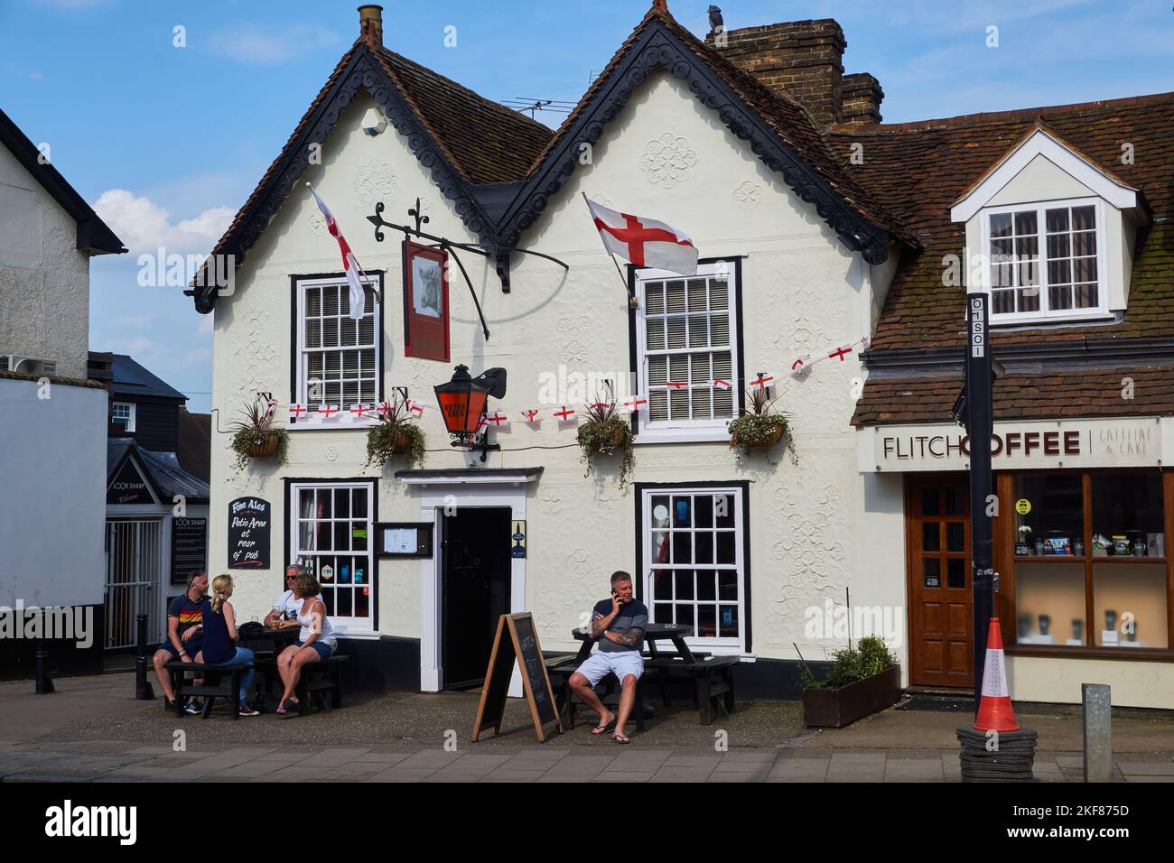 People drinking outside The Boars Head pub in Great Dunmow High Street