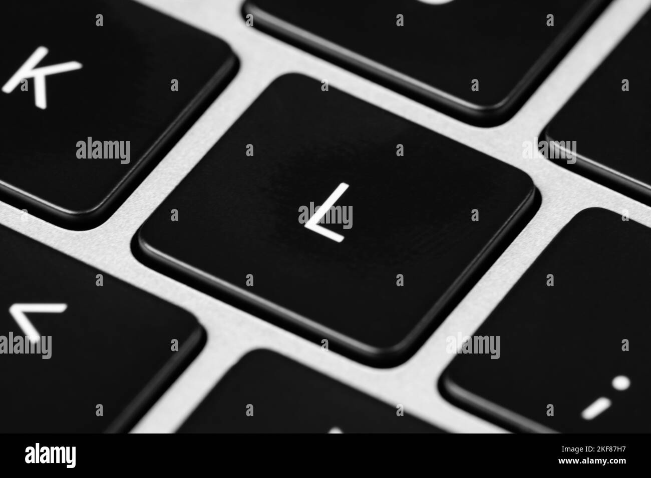 A closeup shot of a grey keyboard layout with black keys and white font Stock Photo
