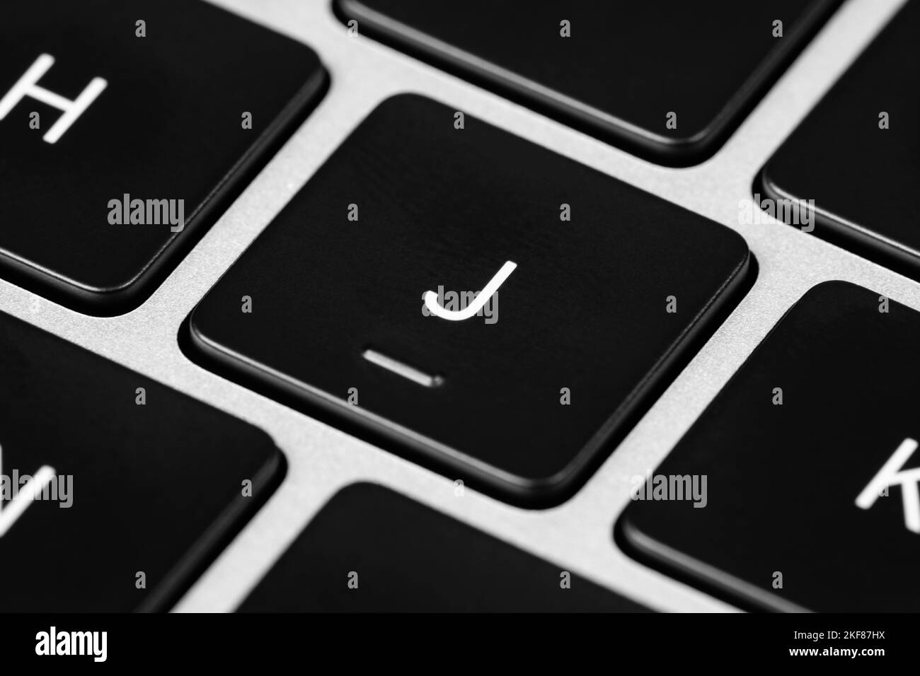 A closeup shot of a grey keyboard layout with black keys and white font ...