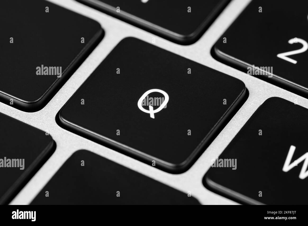 A closeup shot of a grey keyboard layout with black keys and white font Stock Photo