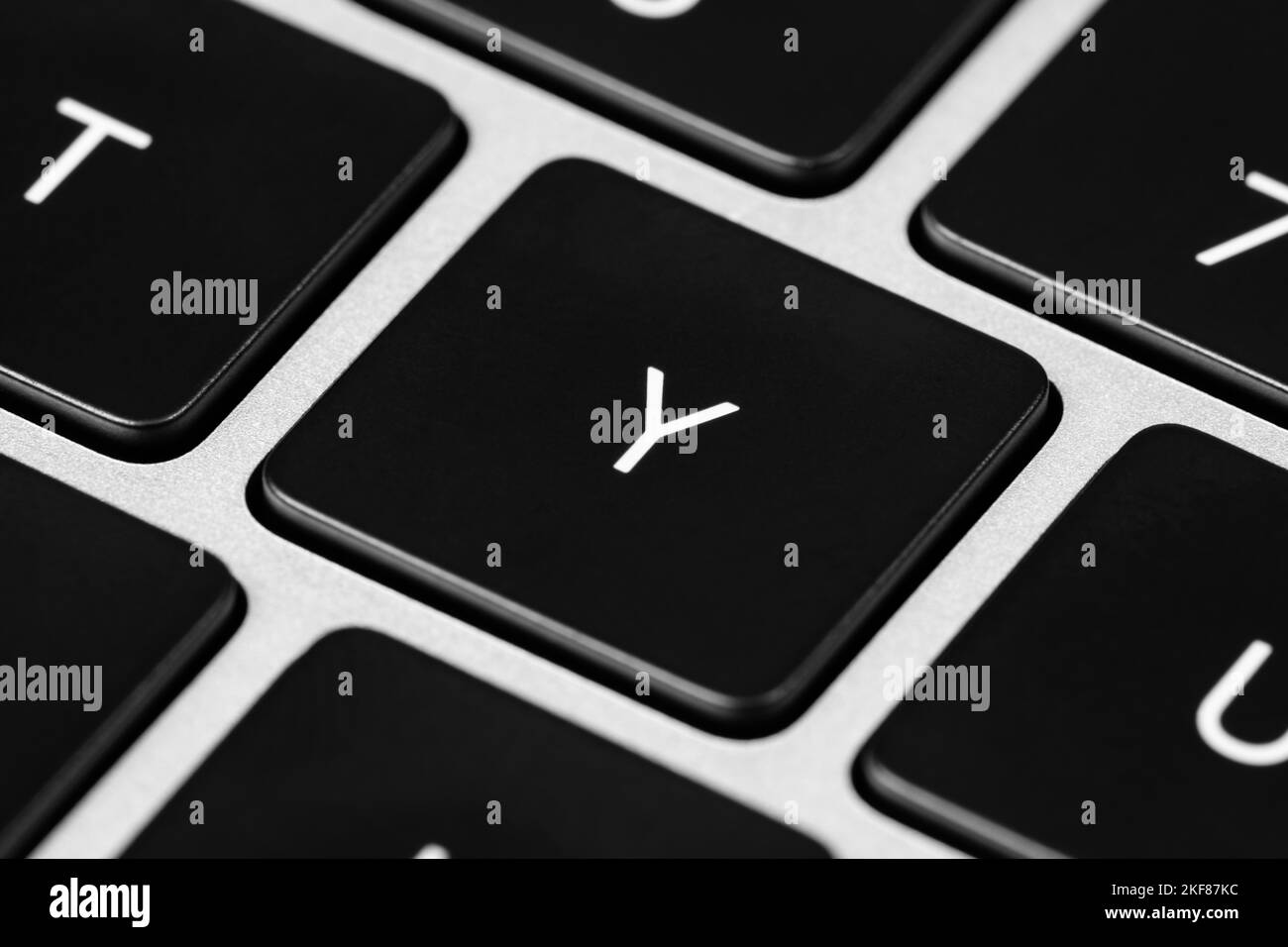 A closeup shot of a grey keyboard layout with black keys and white font ...