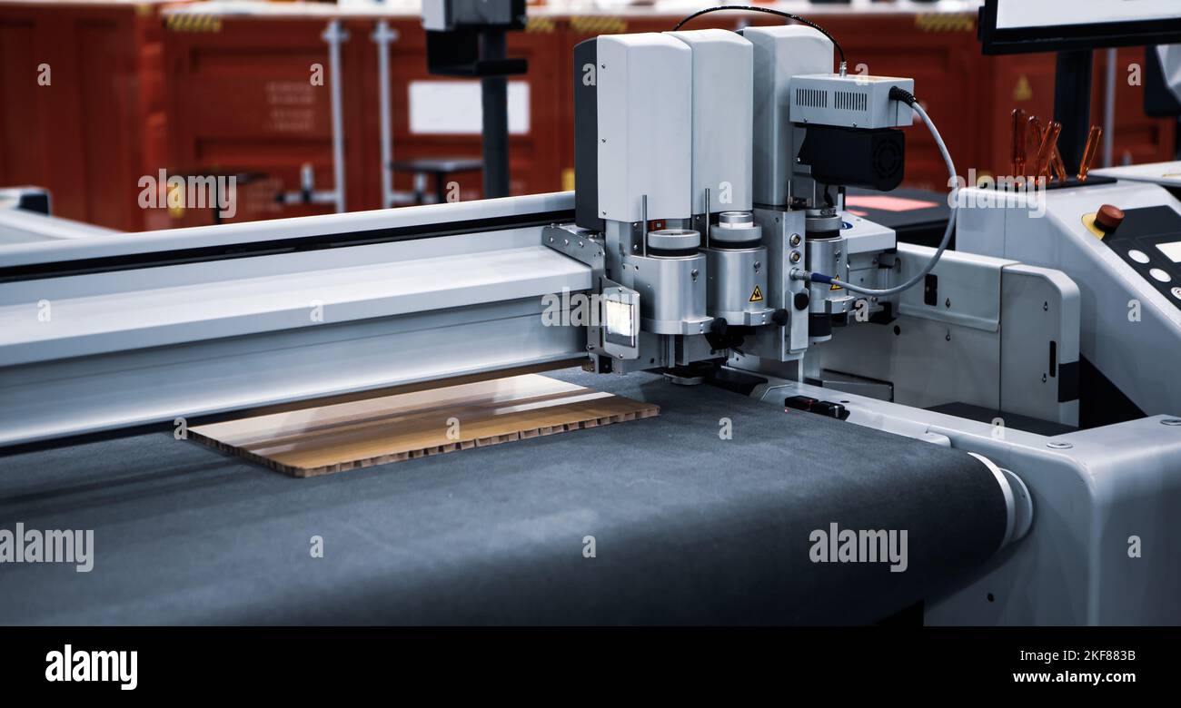 Digital laser die cut machine cutting corrugated cardboard. Industrial