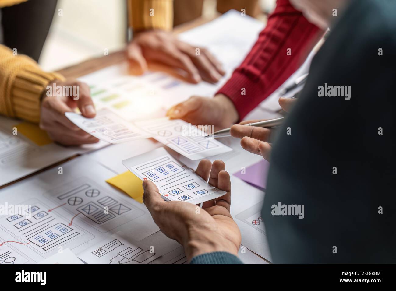 Group of ux developer and ui designer brainstorming about app interface design at modern office. Creative digital development agency Stock Photo