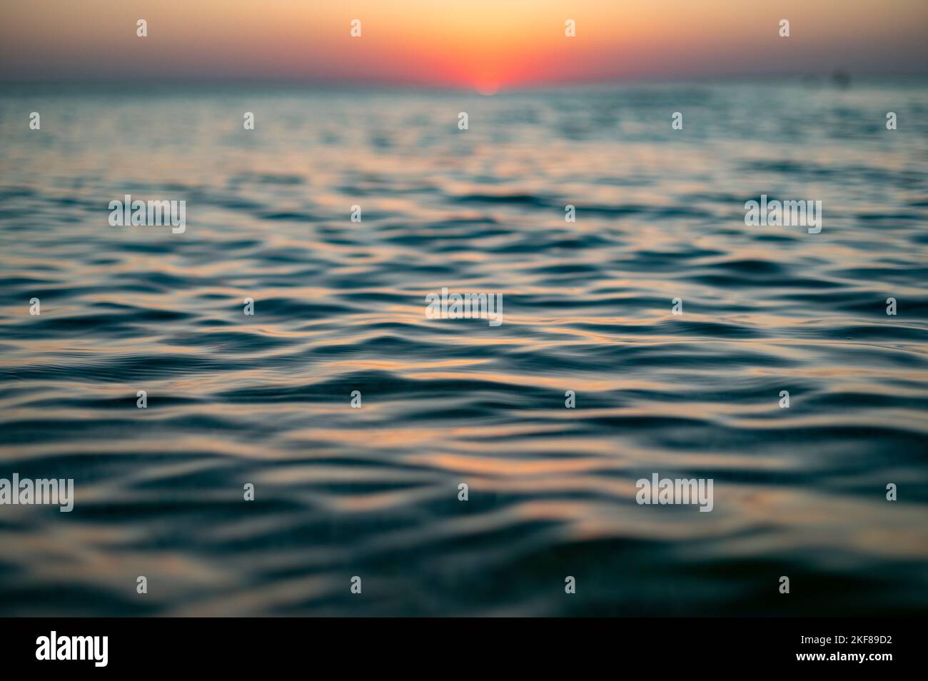 Close up of sea surface on sunset. Water background Stock Photo - Alamy