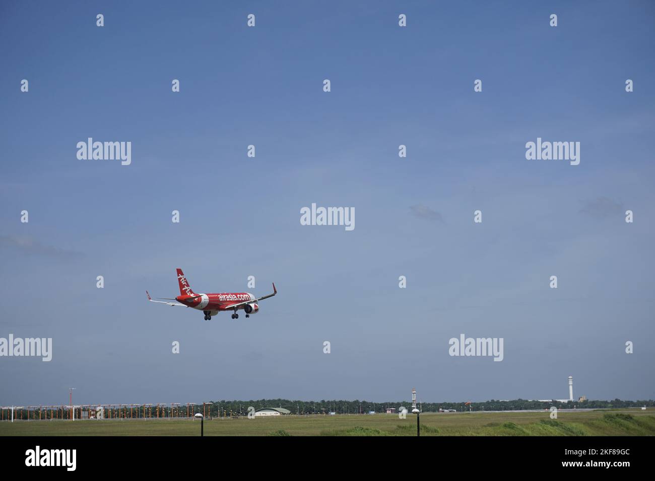 Air Asia budget airline airplane landing at KLIA2 Stock Photo
