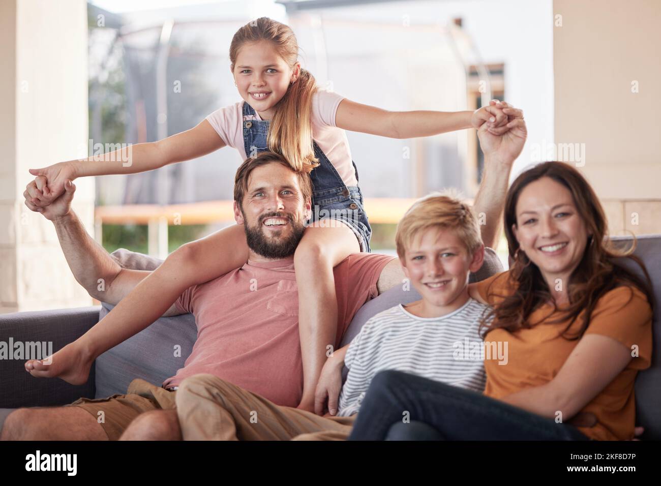 Family, love and relax on a sofa by children with parents in living room, happy and smile while bonding in their home. Portrait, happy family and kids Stock Photo