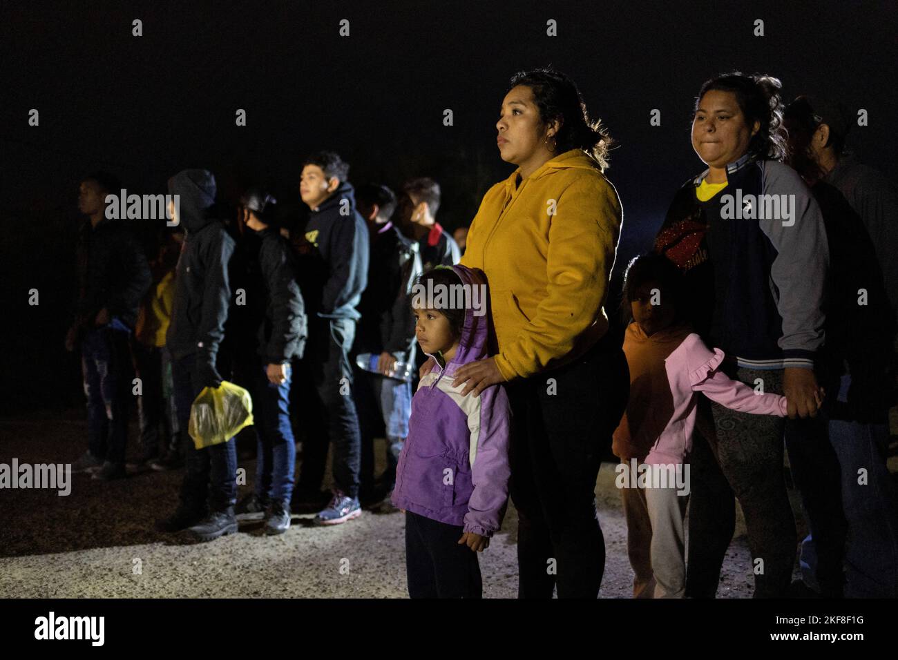Asylum seeking migrants from Central and South America wait to be registered by border patrol agents after being smuggled across the Rio Grande river from Mexico into Roma, Texas, U.S., November 16, 2022.  REUTERS/Adrees Latif Stock Photo