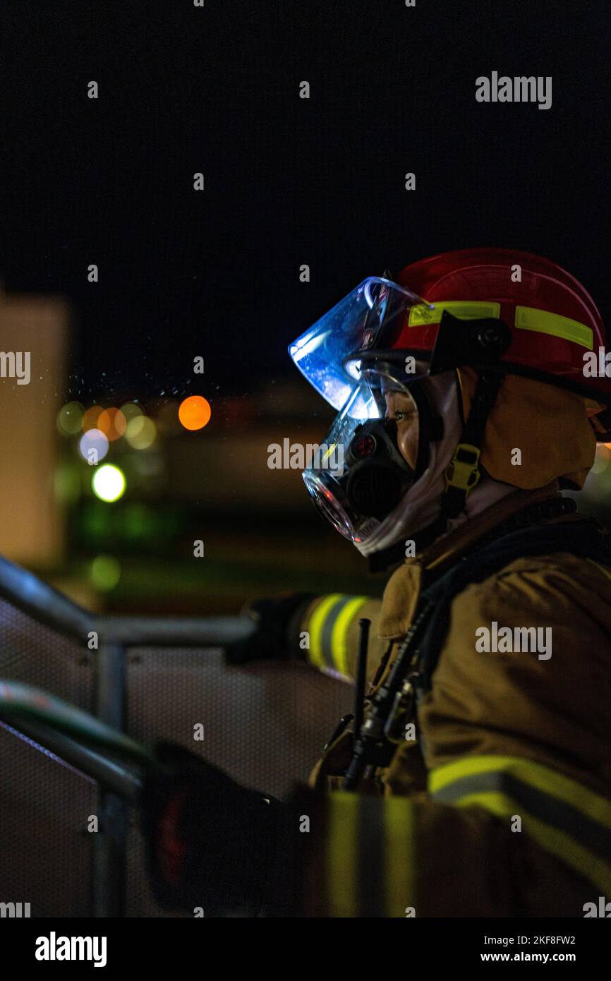 A firefighter with the Marine Corps Air Station Iwakuni Fire and Emergency Services ascends a staircase to the access point of a simulated structure fire during Exercise Active Shield at MCAS Iwakuni, Japan, Nov. 15, 2022. Active Shield is an annual training exercise that is critical to the air station’s ability to maintain mission readiness and enhance bilateral collaboration in order to sustain military operations in support of the U.S.-Japan Alliance. (U.S. Marine Corps photo by Cpl. Mitchell Austin) Stock Photo