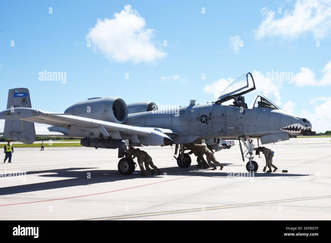 Five 23rd Air Expeditionary Wing Airmen push an A-10C Thunderbolt II into position at Saipan International Airport in Saipan, Commonwealth of the Northern Mariana Islands, Nov. 7, 2022. 23rd AEW and ARFF members learned from shared aircraft familiarization and first responder emergency procedure training. (U.S. Air Force photo by 1st Lt. Christian Little) Stock Photo
