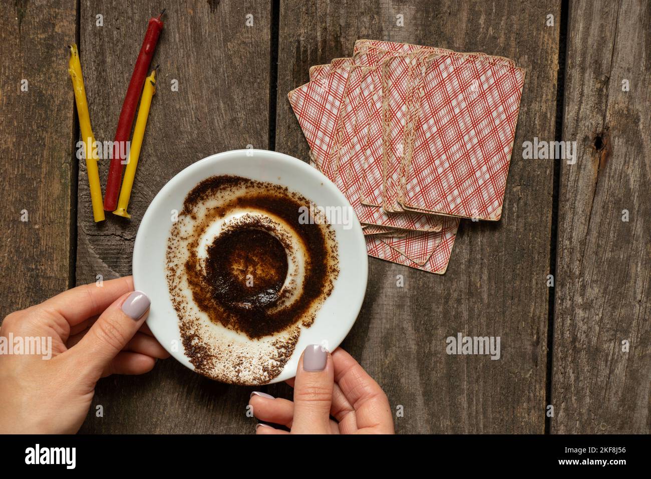 coffee grounds in the hands of a fortune teller and cards and candles
