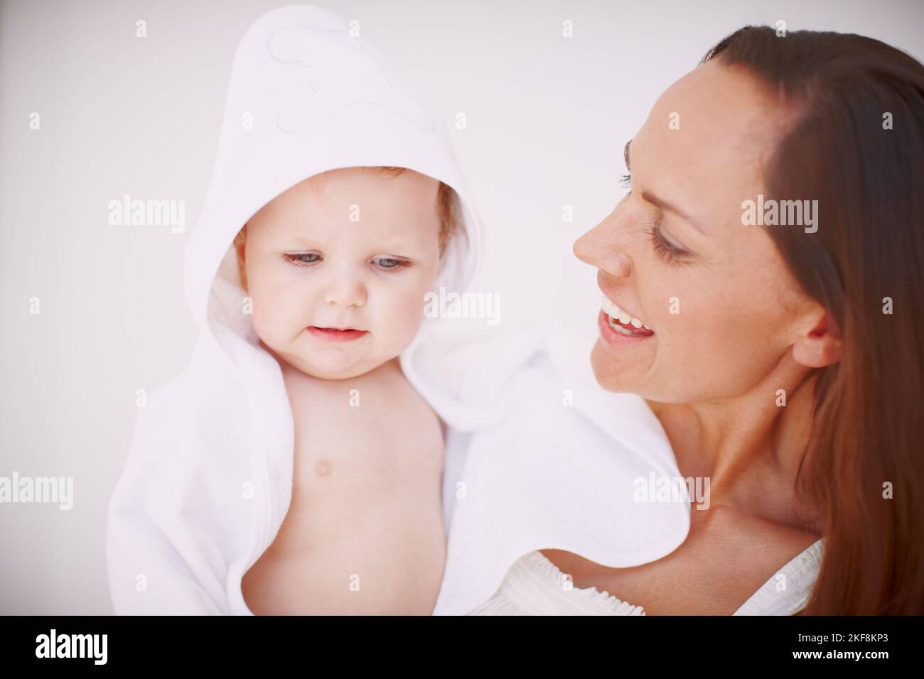 Shes Moms little angel. A baby girl wrapped in a towel and being held