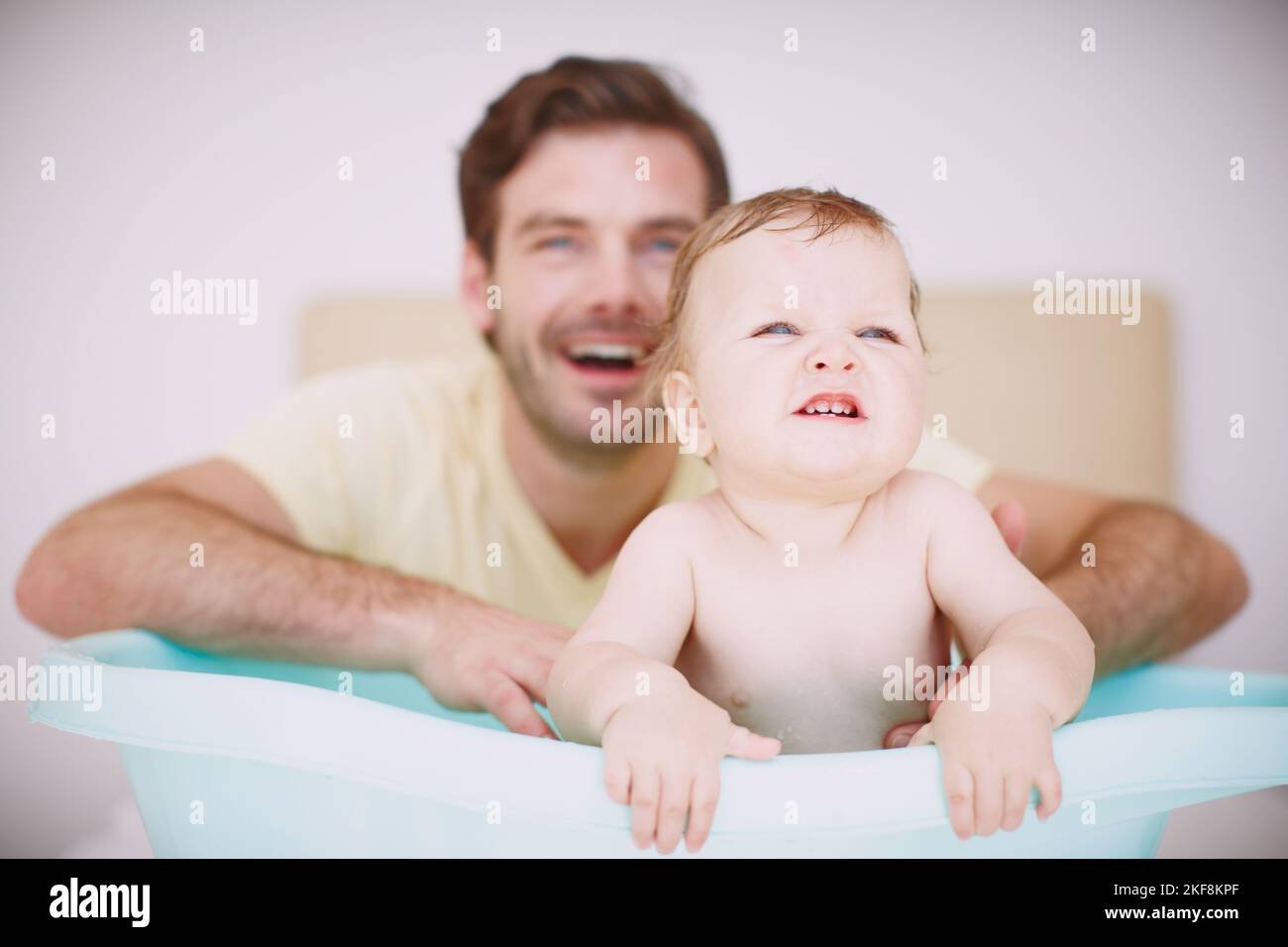 This bathtub isnt big enough for me. A baby girl sitting in the bathtub