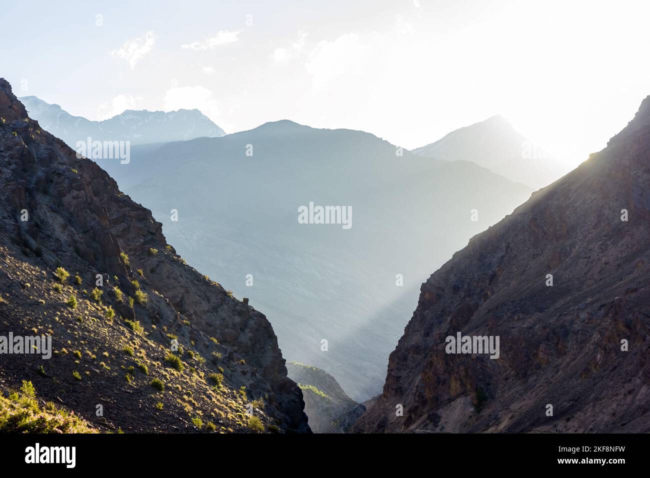 Sunlight filtering through the steep cliffs and deep gorges of the canyons of the mountains in Zanskar. Stock Photo