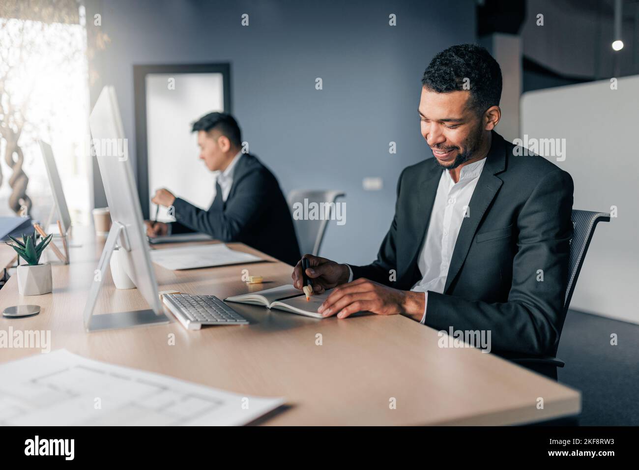 African businessman taking notes during working day in office on ...