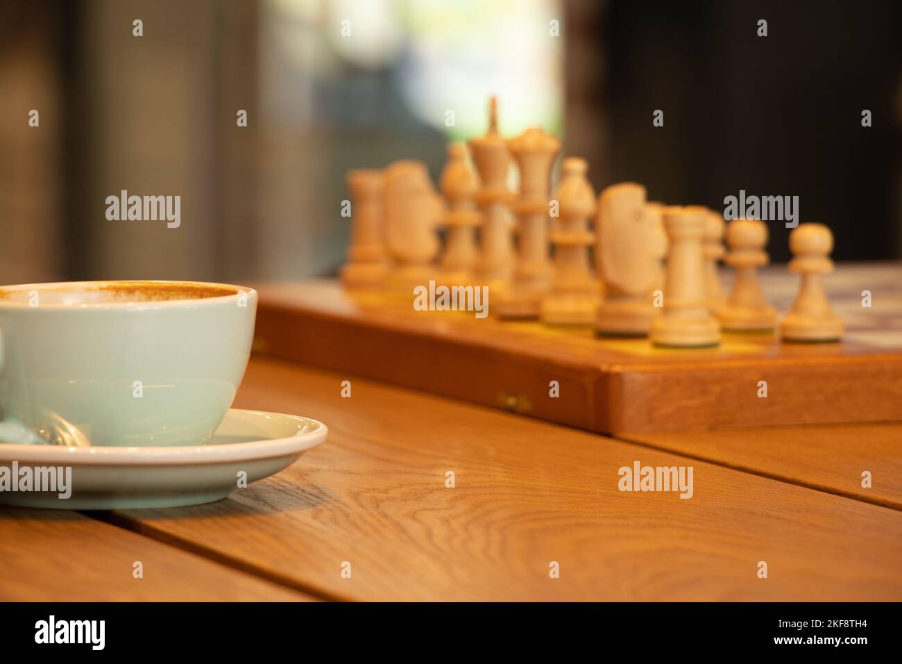 brown chess board with figures on a wooden table in a cafe, playing chess  Stock Photo - Alamy