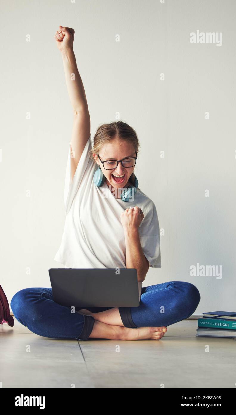 Laptop, excited and woman in celebration for a win on an online game on the internet with technology. Computer, good news and girl student celebrating Stock Photo