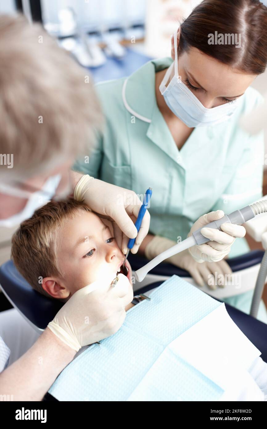 Young dental patient. Portrait of young dental patient taking treatment at dentist clinic Stock