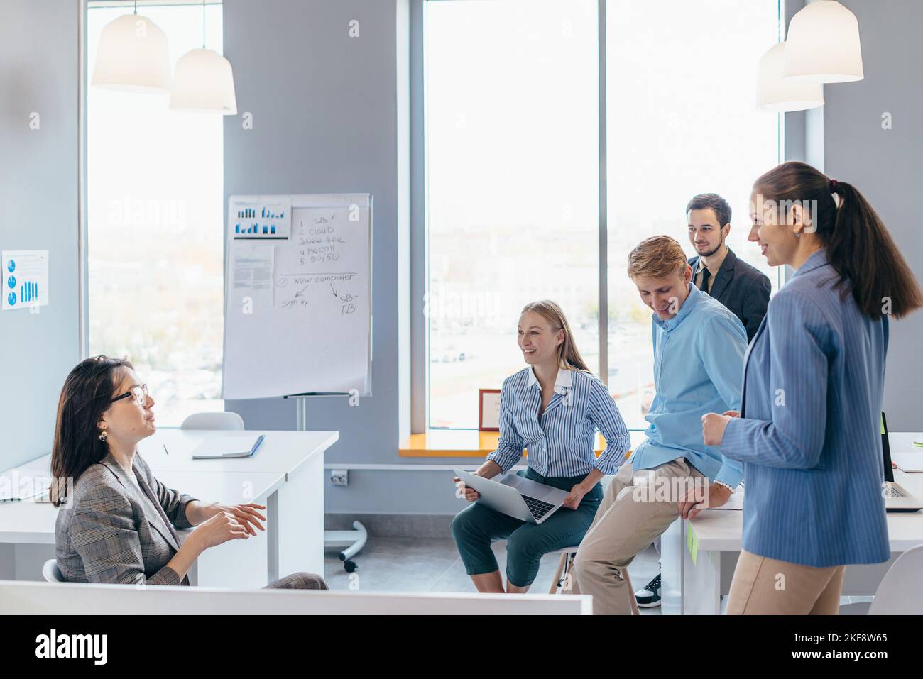 Business woman making a presentation to her colleagues during meeting