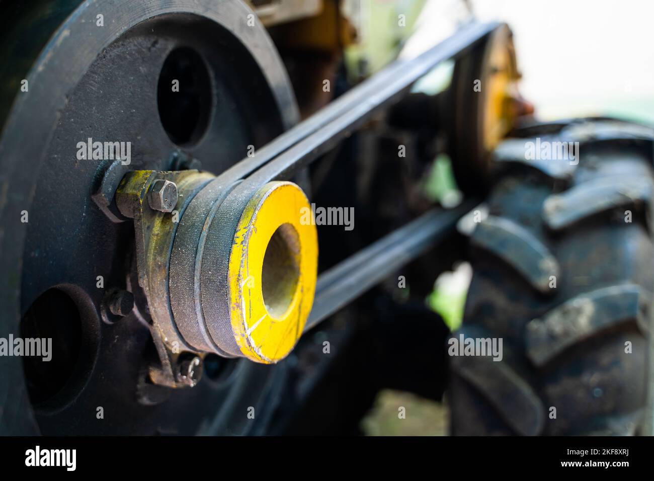 Walkbehind tractor pulley with two belts closeup. Tractor for