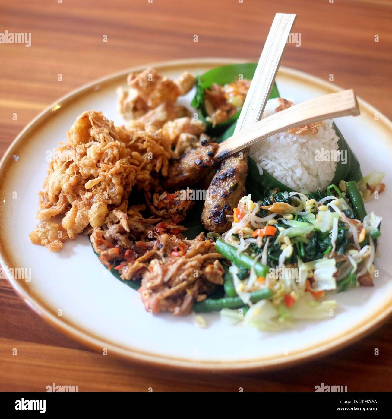Nasi Campur Bali. Balinese dish of steamed rice with variety of side dishes Stock Photo