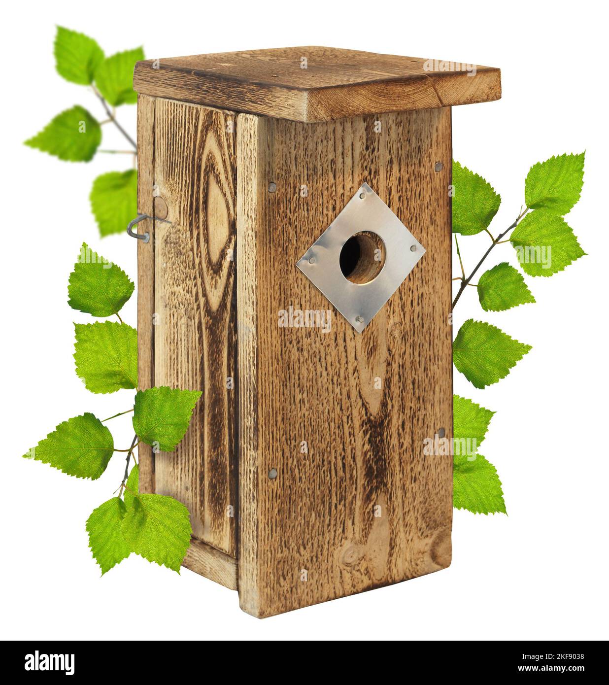 Wooden birdhouse self-made nesting box with green birch tree leaves, spring time concept, isolated Stock Photo