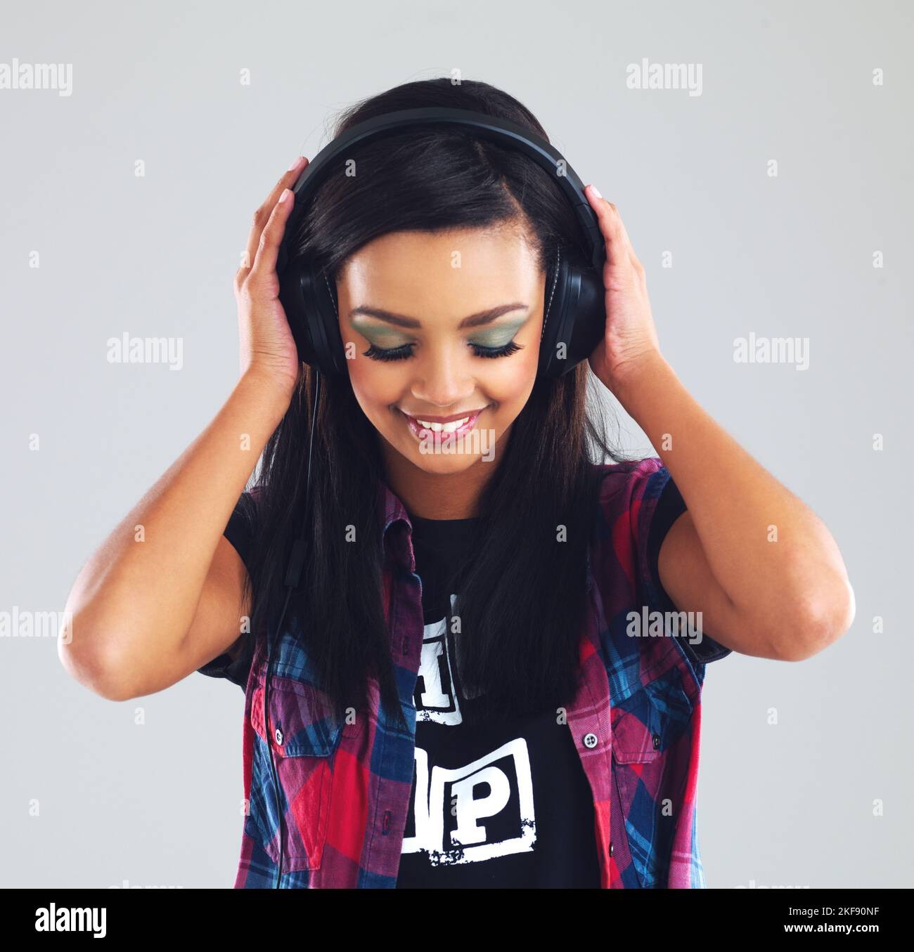 Weve all got that one song...Studio shot of a young woman listening to ...