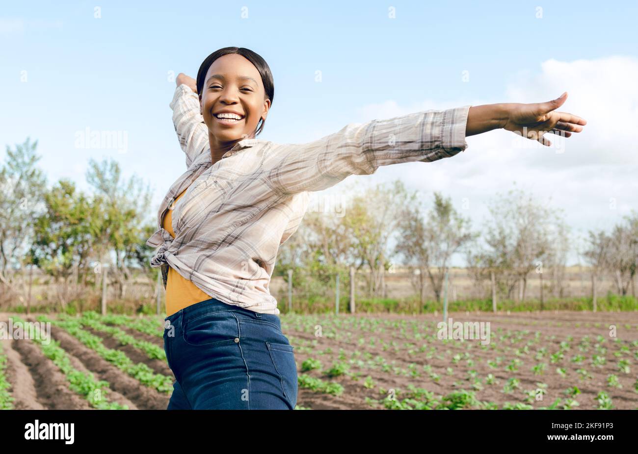 Agriculture, black woman and farmer and environment with farm harvest and farming for sustainability in countryside. Green, sustainable and freedom Stock Photo