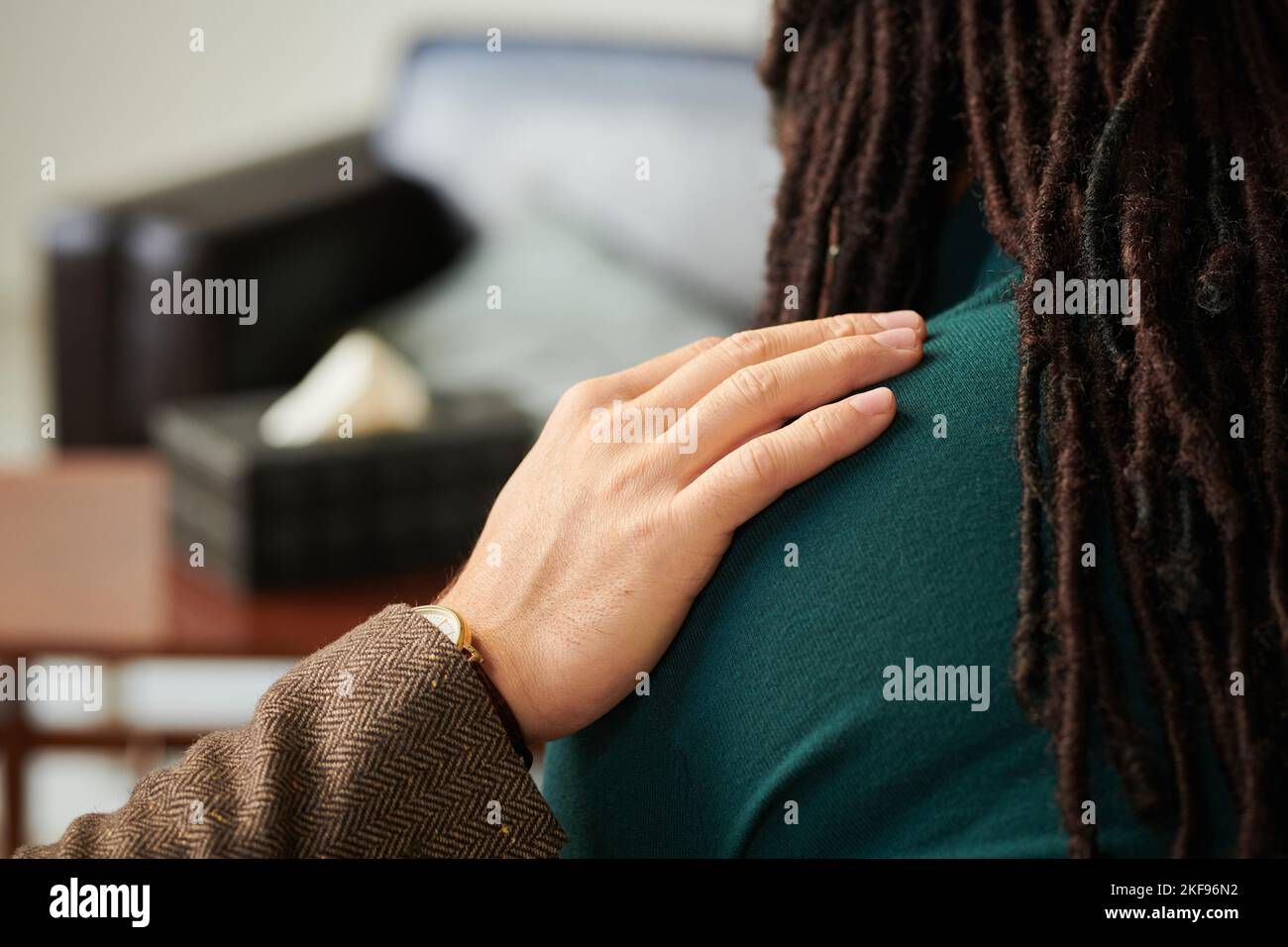 Rear view of psychologist supporting patient during psychotherapy session at office Stock Photo
