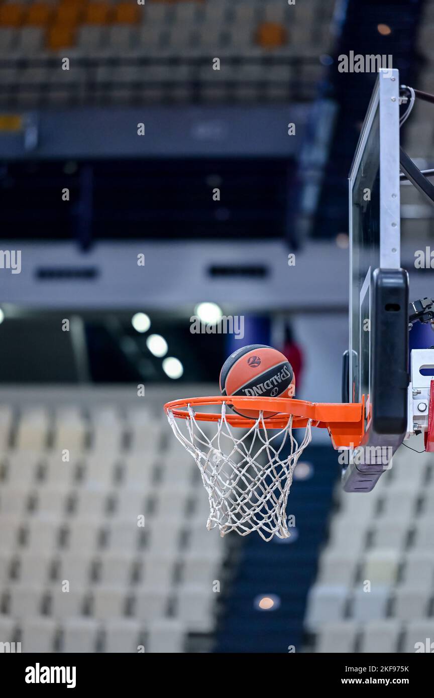 Basket ball entering the net in a basketball court with empty seats