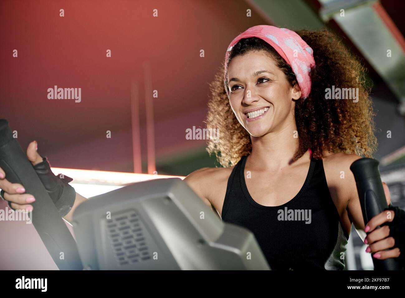 Every workout is worth it. a young woman working out with a stepping machine at the gym. Stock Photo