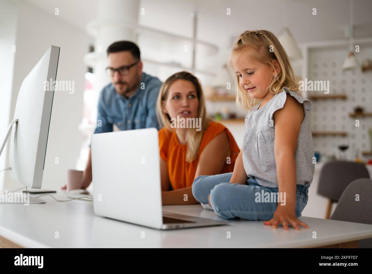 Working from home with child. Busy business parents working while kid