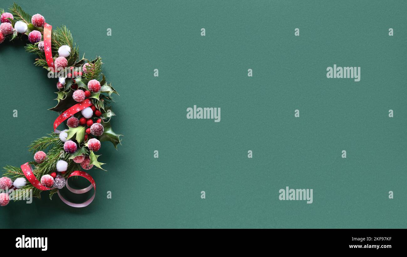 Christmas wreath with holly, fir twigs and frosted red berries. Flat ...
