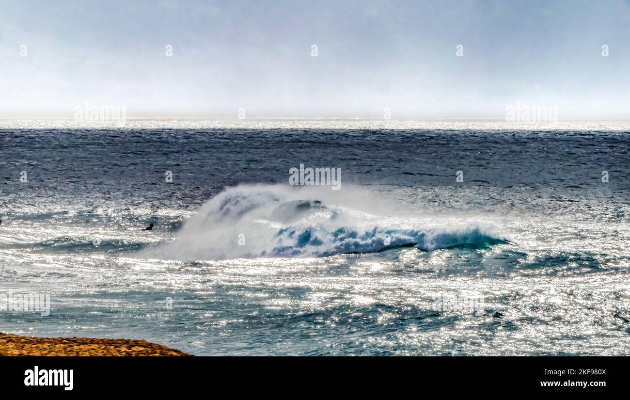 Colorful Banzai Pipeline Surfers Swimmers North Shore Oahu Hawaii. One of the most famous surfing spots Stock Photo