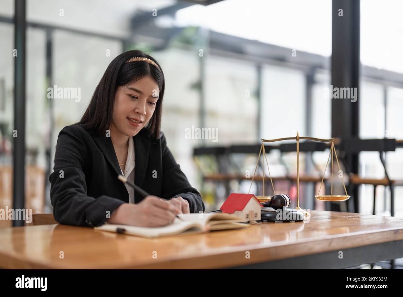 Portrait confidence asian lawyer taking note sitting at work desk in office. real estate concept. Stock Photo